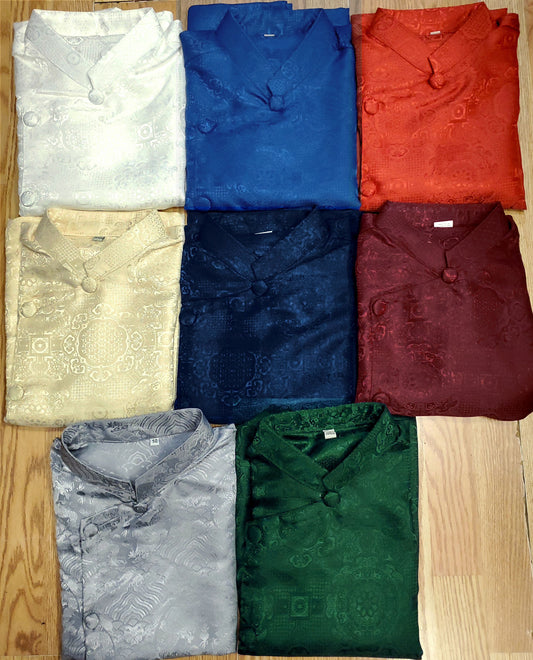 Collection of folded shirts in various colors on a wooden surface