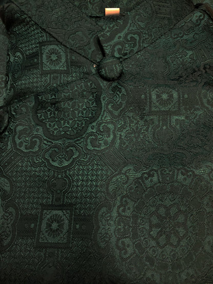 Dark green patterned fabric with a close-up view